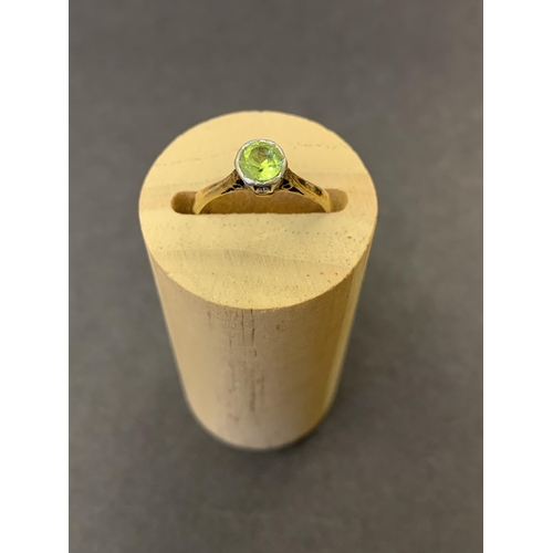 121 - An 18ct gold and platinum peridot set ring, approx. size K 1/2, weight approx. 2g