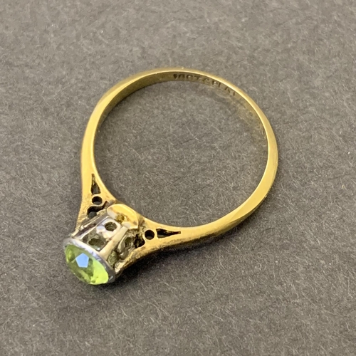 121 - An 18ct gold and platinum peridot set ring, approx. size K 1/2, weight approx. 2g