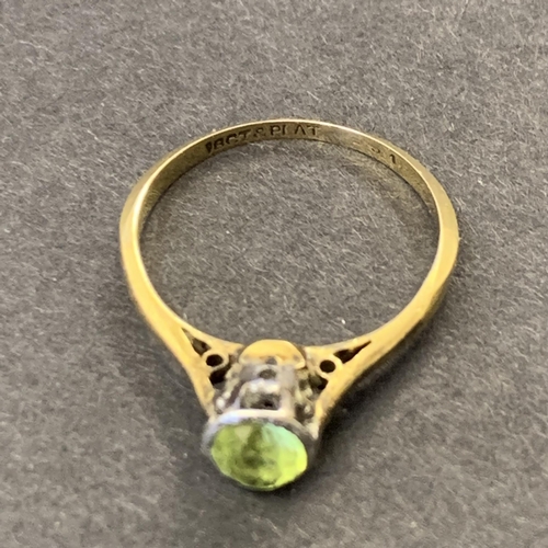 121 - An 18ct gold and platinum peridot set ring, approx. size K 1/2, weight approx. 2g