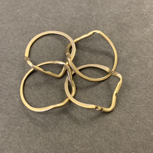 123 - A deconstructed yellow metal puzzle ring, appears unmarked, weight approx. 2.7g