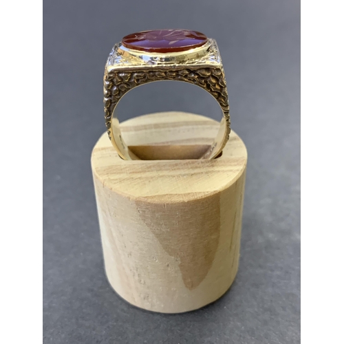 129 - A chunky 9ct gold and carved carnelian seal stone set ring, approx. size U, weight approx. 10.5g