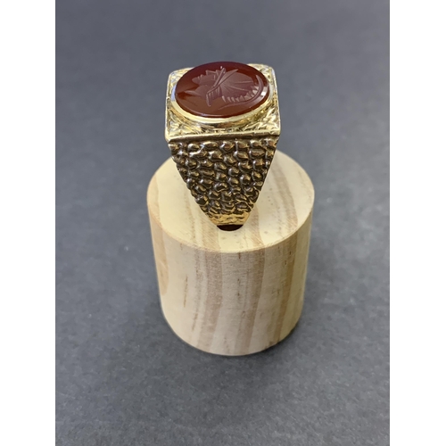 129 - A chunky 9ct gold and carved carnelian seal stone set ring, approx. size U, weight approx. 10.5g