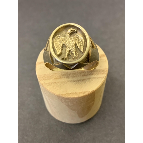 130 - A 9ct gold ring with bird emblem to top, possibly a seal, approx. size T, weight approx. 7g (the sha... 