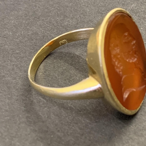 133 - A gold ring set with carved carnelian seal, possibly of Shakespeare, marks rubbed but '18' is visibl... 