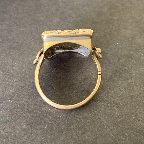 138 - An antique Victorian 9ct gold mourning ring, the top section with preserved hair in an ornate settin... 