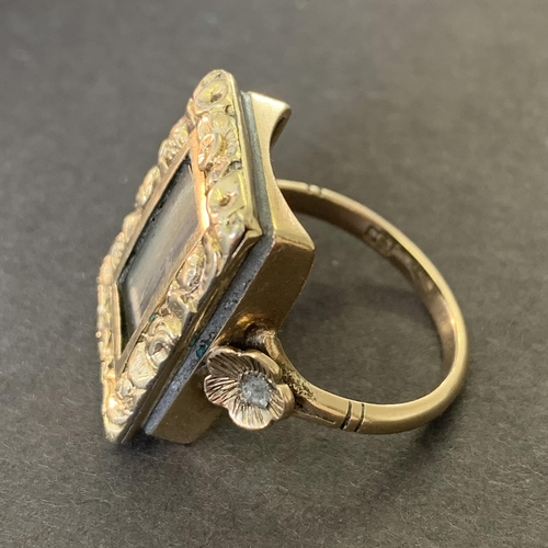 138 - An antique Victorian 9ct gold mourning ring, the top section with preserved hair in an ornate settin... 