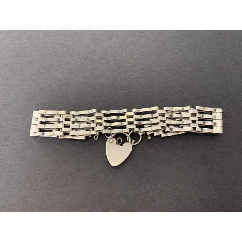 147 - A hallmarked silver and heart locket bracelet, weight approx. 15g (marks rubbed)