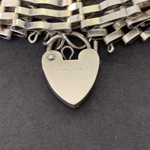 147 - A hallmarked silver and heart locket bracelet, weight approx. 15g (marks rubbed)