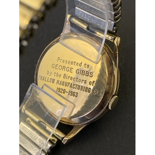 151 - A 9ct gold Buren Grand Prix wristwatch on elasticated yellow metal strap and with engraving on the b... 