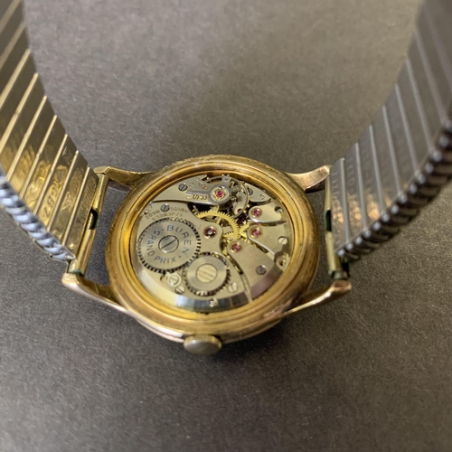 151 - A 9ct gold Buren Grand Prix wristwatch on elasticated yellow metal strap and with engraving on the b... 