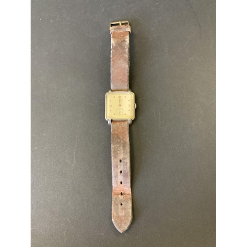 153 - A vintage Roamer wristwatch on brown strap, 27mm wide, ticks and runs (age wear and strap very worn)