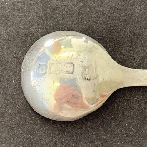 157 - A hallmarked silver rim glass salt plus a hallmarked salt spoon