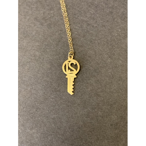 178 - A 9ct gold 21st key on yellow metal chain, total weight approx. 0.9g