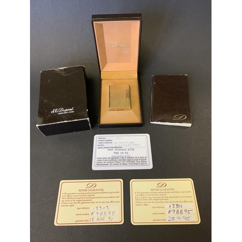 200 - A vintage boxed S J Dupont gold plated lighter with original sales information for 1980, bought in F... 