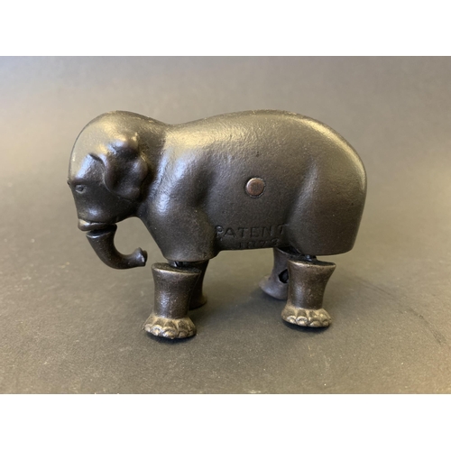 219 - A late 19th Century cast iron walking elephant toy, marked 'Patent 1873', most likely made by the Iv... 