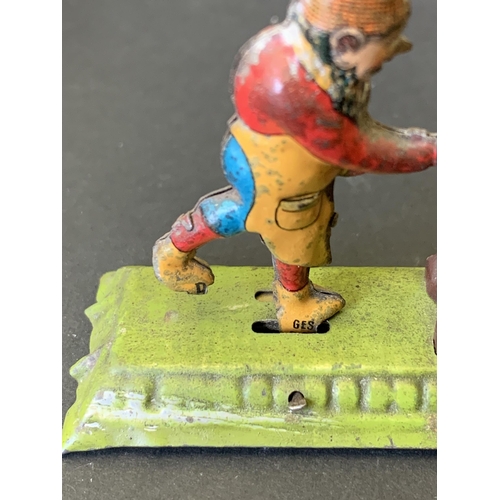 222 - An antique tin plate figure group of gnomes hitting an anvil, possibly by 'Meier' of Germany, marked... 