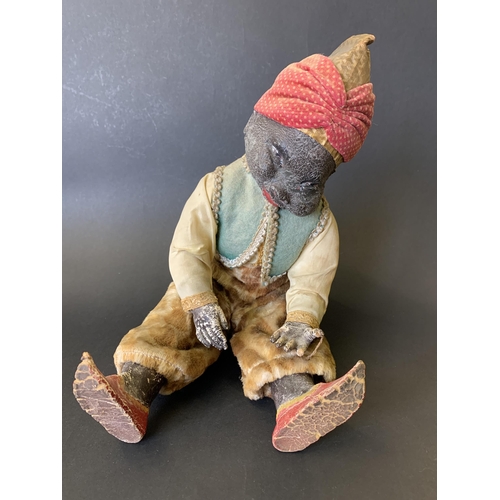 223 - A vintage and unusual Arab/Moorish musical figurine with composite body, the music box winds and pla... 