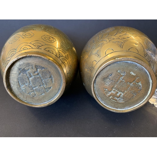 26 - A pair of Oriental polished bronze vases decorated with dragons, approx. 9