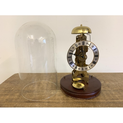 261 - A vintage West German 'Hermle' brass striking skeleton clock under glass dome, approx. 11 1/2