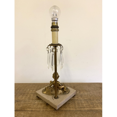 278 - A vintage gilded metal cherub lamp base with cut glass lustres and marble style base, approx. 17