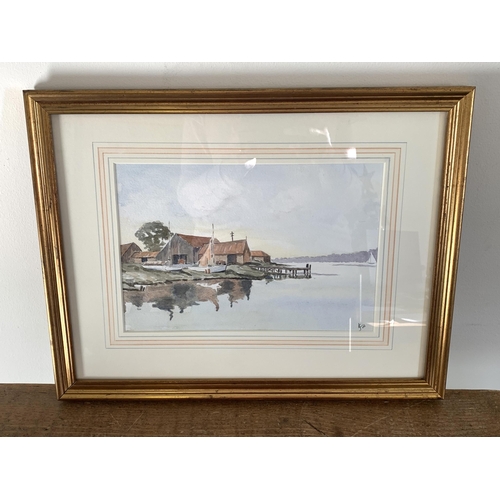 318 - A framed and glazed watercolour of buildings with mooring, monogrammed JC lower right with 05 under,... 