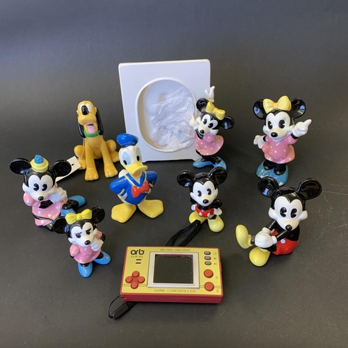 376 - A group of ceramic Disney style figures plus an 'Orb Gaming' retro arcade small hand held game (unte... 