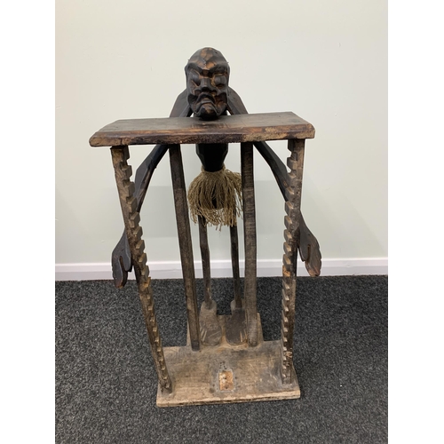 455 - An African style wooden table with carved wooden face, approx. 28