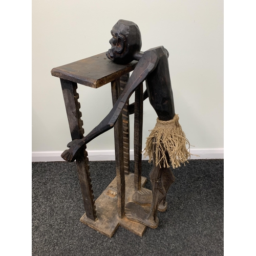 455 - An African style wooden table with carved wooden face, approx. 28