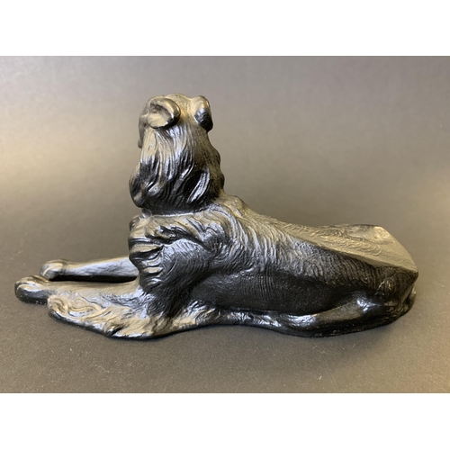 46 - A cast metal black painted dog figurine, possibly Russian, maker marked on inside, approx. 7