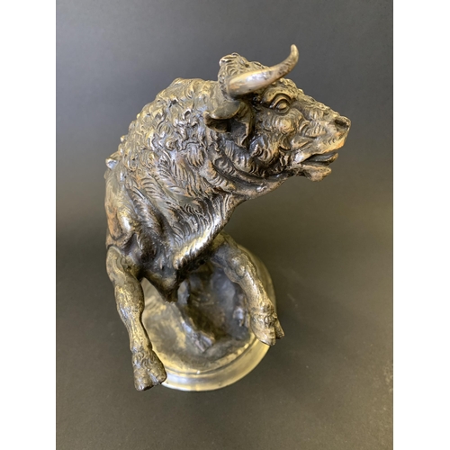 48 - A cast metal bull figurine with a white metal finish, in rearing pose with a sword in his back (and ... 