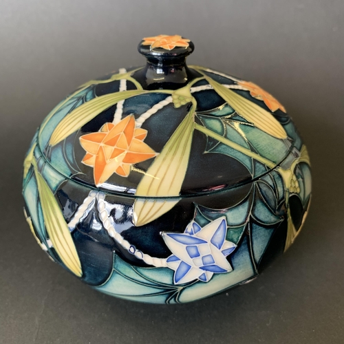 62 - A Moorcroft Trial lidded pot in the 'Festive Lights' pattern, marked 'Trial 25.10.02' to base, appro... 