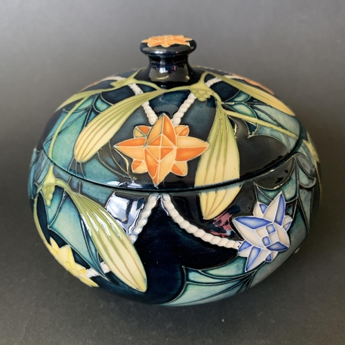 62 - A Moorcroft Trial lidded pot in the 'Festive Lights' pattern, marked 'Trial 25.10.02' to base, appro... 