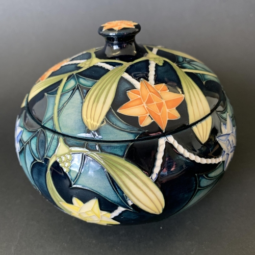 62 - A Moorcroft Trial lidded pot in the 'Festive Lights' pattern, marked 'Trial 25.10.02' to base, appro... 