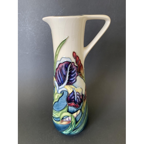 67 - A Moorcroft jug in the 'Iris' pattern, marked M.C.C. 1089 (Moorcroft Collectors Club), approx. 9 1/4... 