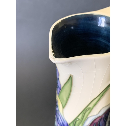 67 - A Moorcroft jug in the 'Iris' pattern, marked M.C.C. 1089 (Moorcroft Collectors Club), approx. 9 1/4... 