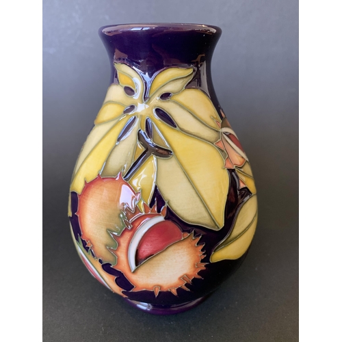 69 - A Moorcroft limited edition vase in an unusual pattern decorated with chestnuts and leaves, possibly... 