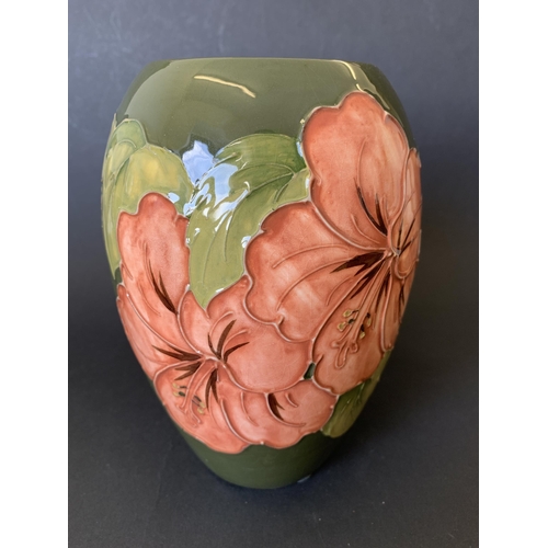 72 - A Moorcroft vintage vase in the 'Hibiscus' pattern on green ground and with green signature to base,... 