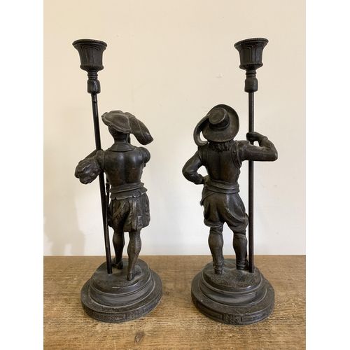 85 - A pair of antique spelter, possibly Musketeer, candlesticks, 13 3/4