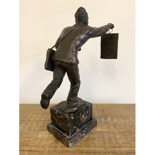 86 - A vintage bronze figurine of a running man carrying a telegraph satchel and carrying a plaque readin... 