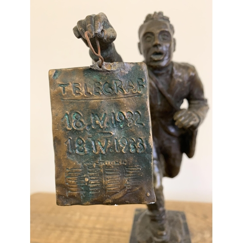 86 - A vintage bronze figurine of a running man carrying a telegraph satchel and carrying a plaque readin... 