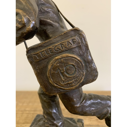 86 - A vintage bronze figurine of a running man carrying a telegraph satchel and carrying a plaque readin... 