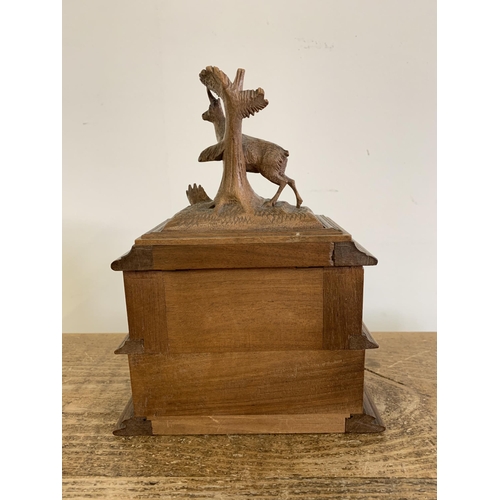 87 - A vintage Black Forest style wooden jewellery box decorated with a deer to the top (horns as found),... 