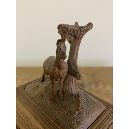 87 - A vintage Black Forest style wooden jewellery box decorated with a deer to the top (horns as found),... 