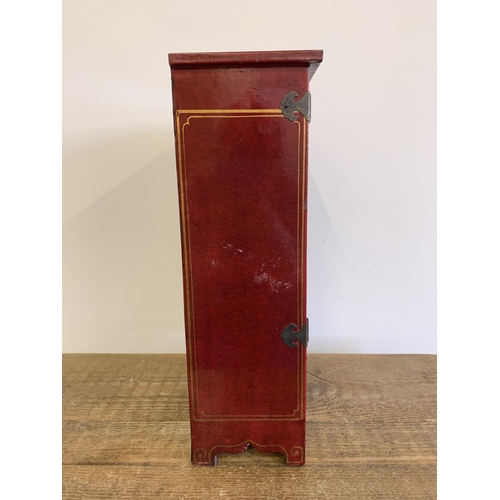 88 - A vintage Oriental style red painted jewellery cabinet with two drawers, stands 16