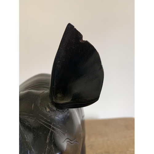 93 - An antique carved ebony rhinoceros with bone inset teeth and toenails, approx. 12 3/4