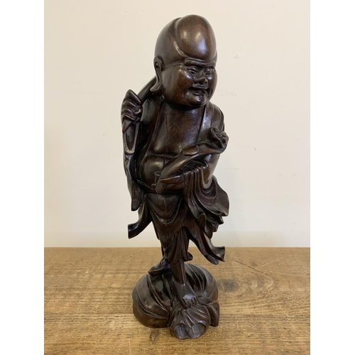 94 - A vintage carved wooden Oriental God figure, approx. 13 3/4