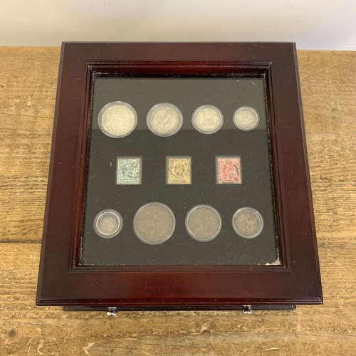 153 - Danbury Mint George V coins and stamp set housed in a wooden glazed case with drawer, silver weight ... 