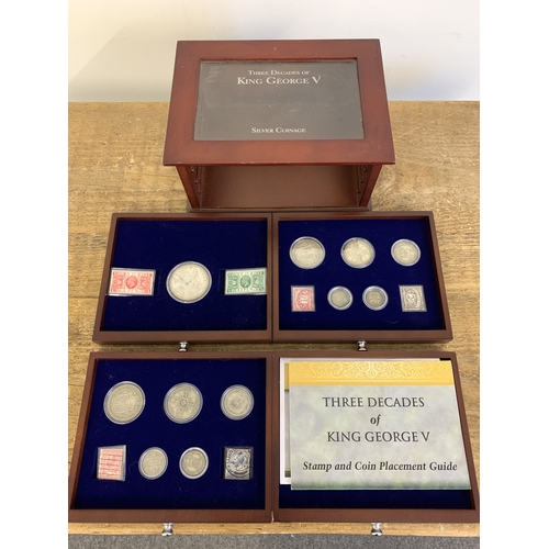 154 - Danbury Mint 'Three Decades of King George V' silver coinage and stamps housed in a wooden and glaze... 