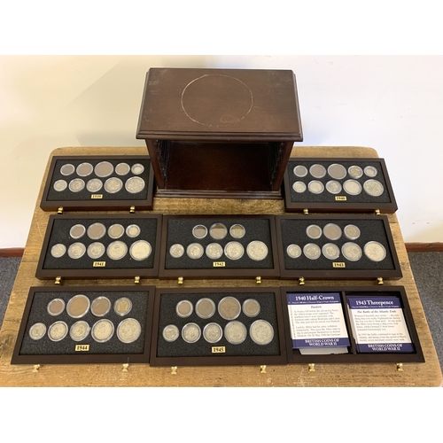 156 - Danbury Mint British coins of WW2 housed in a wooden display unit with eight drawers, pre 1947 silve... 