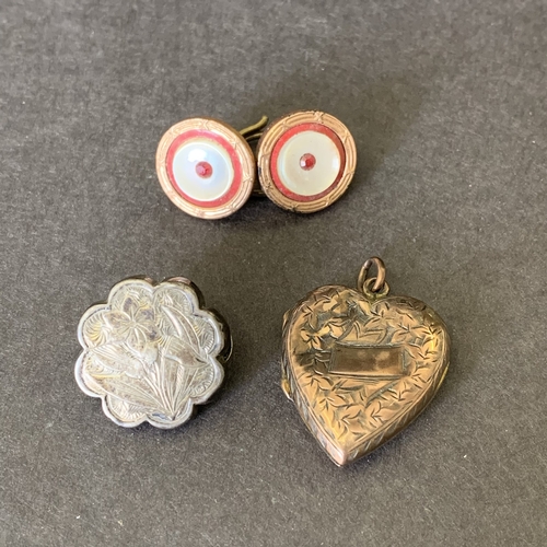 169 - A vintage rose metal heart locket together with rose and white metal buttons and a brooch (as found)